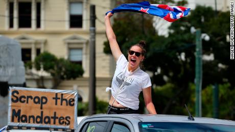 Un manifestante ondea una bandera detrás de un automóvil en Wellington el martes.